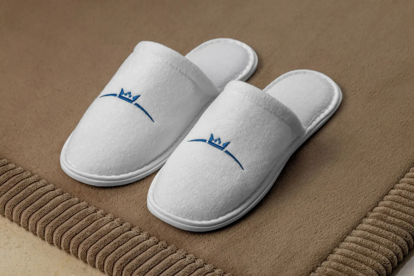 White guest slippers on a mat in a Superior Deluxe Ocean View room at Sun Palace Cancun.