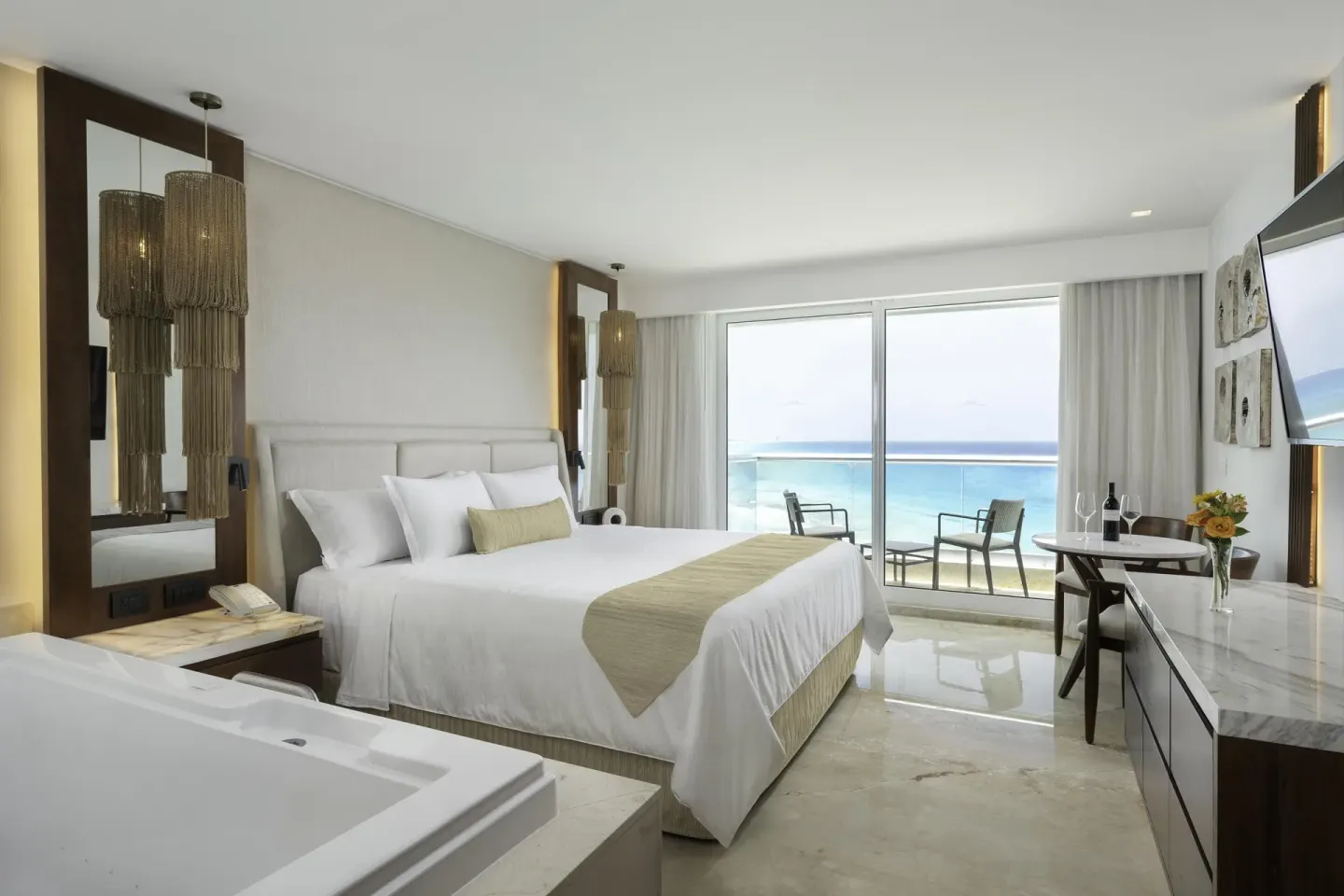 Superior Deluxe Ocean View king room at Sun Palace Cancun with balcony chairs and ocean view.