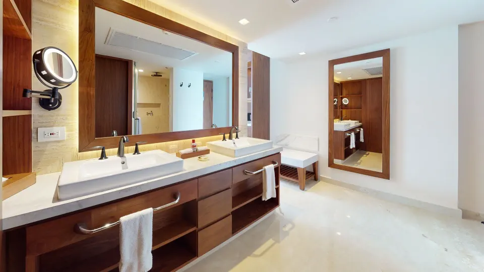 Superior Deluxe Ocean View bathroom with double sinks and mirrors at Sun Palace Cancun.