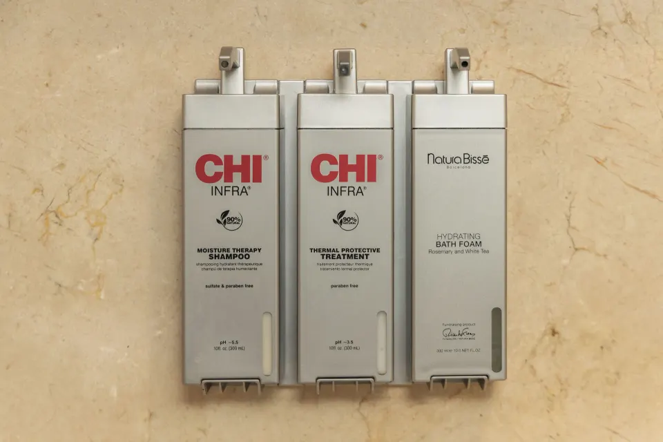 Wall-mounted shower amenity dispensers in a guest bathroom at Sun Palace Cancun.