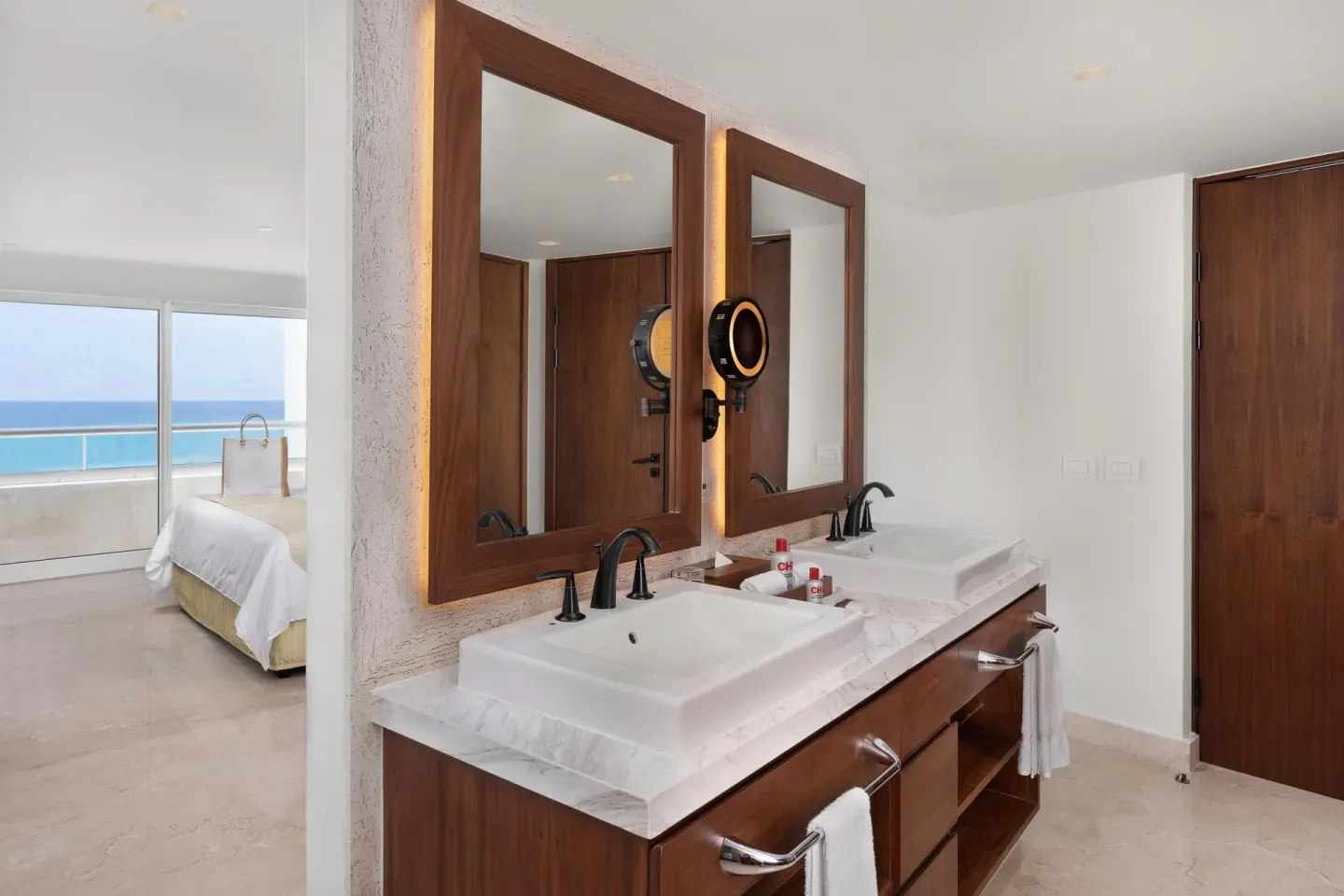 Superior Governor Suite bathroom vanity with dual sinks and bedroom view at Sun Palace Cancun.