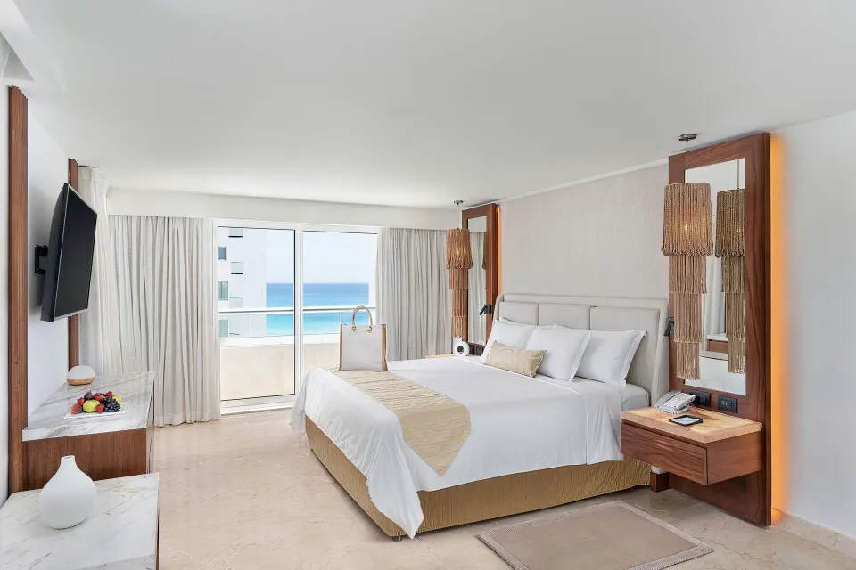 Superior Governor Suite king bed with balcony ocean view at Sun Palace Cancun.