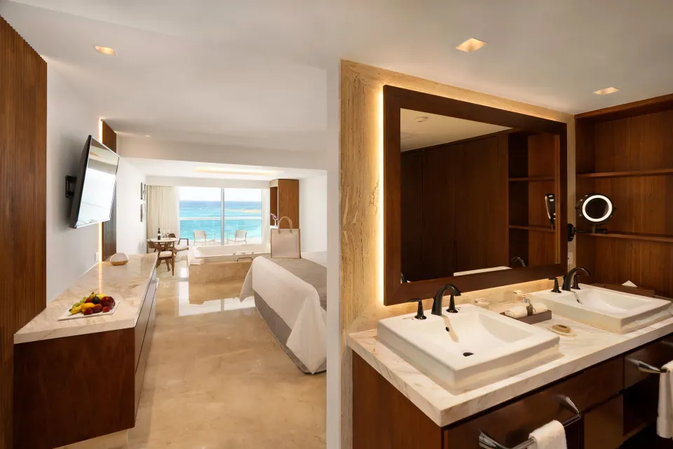 Superior Honeymoon Suite Ocean View bathroom and king bed at Sun Palace Cancun.