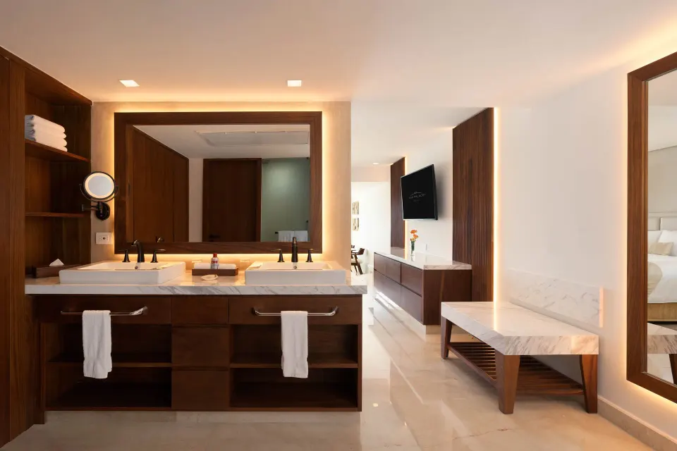Superior Junior Suite Ocean View bathroom vanity and bedroom entry at Sun Palace Cancun.