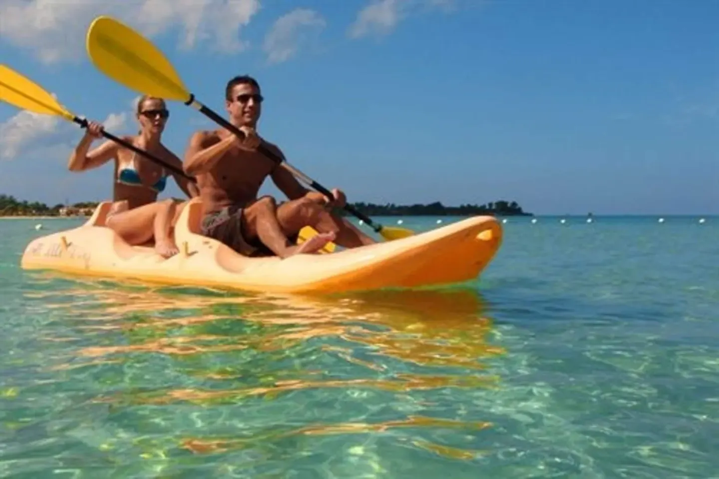 Guests kayak on clear Caribbean water at Sunset at the Palms Resort.