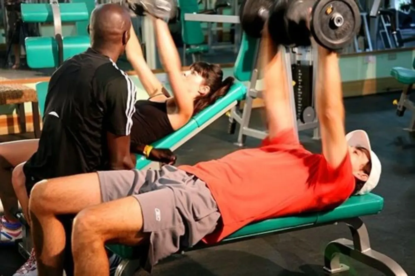 Guests lifting dumbbells in the fitness center at Sunset at the Palms Resort.