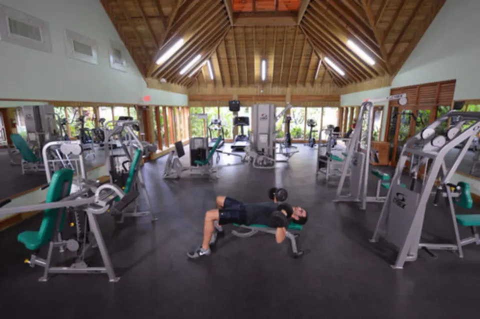 Spacious fitness center with weight machines at Sunset at the Palms Resort.