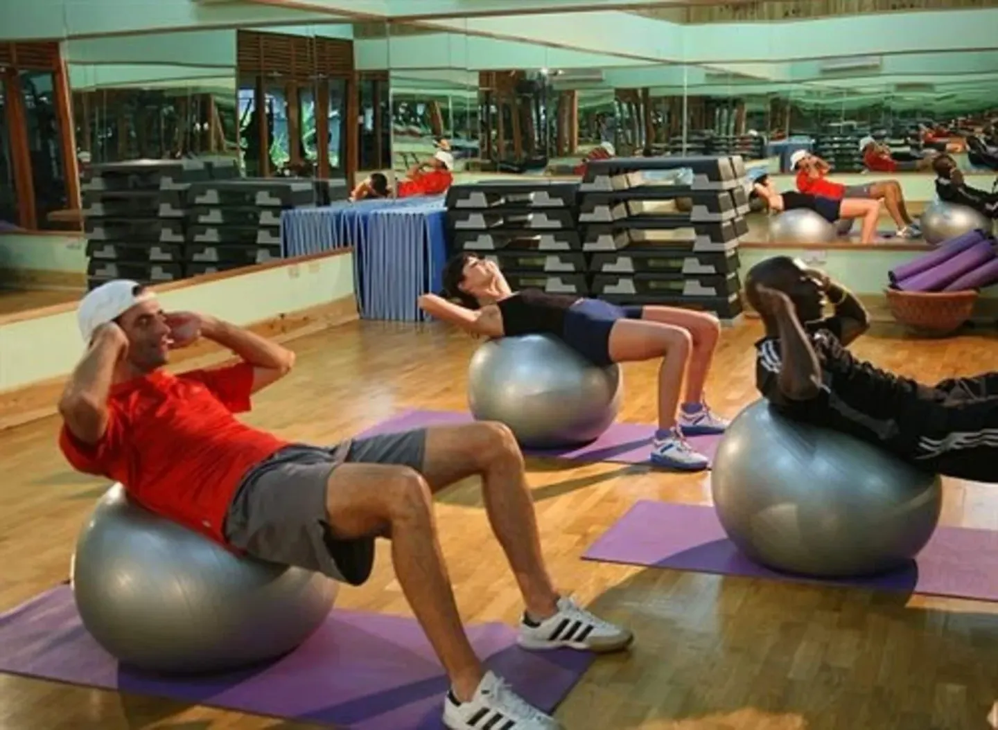Guests exercising on stability balls in the fitness studio at Sunset at the Palms Resort.