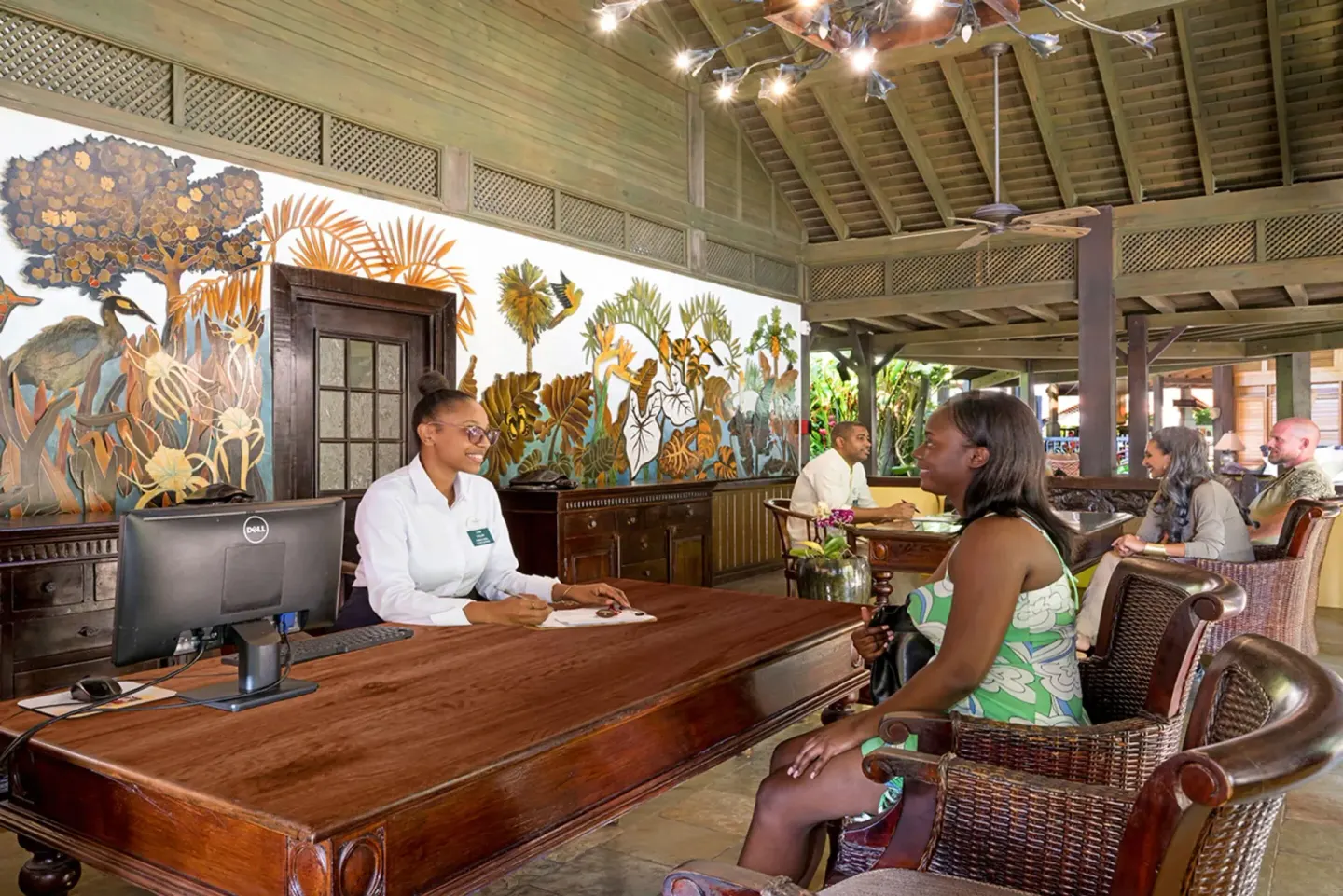 Guest reception desk and mural wall in the lobby at Sunset at the Palms Resort.