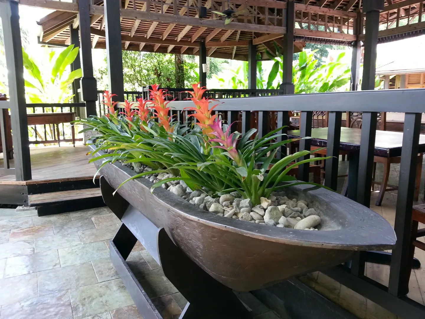Planter with tropical flowers in an open-air pavilion at Sunset at the Palms Resort.