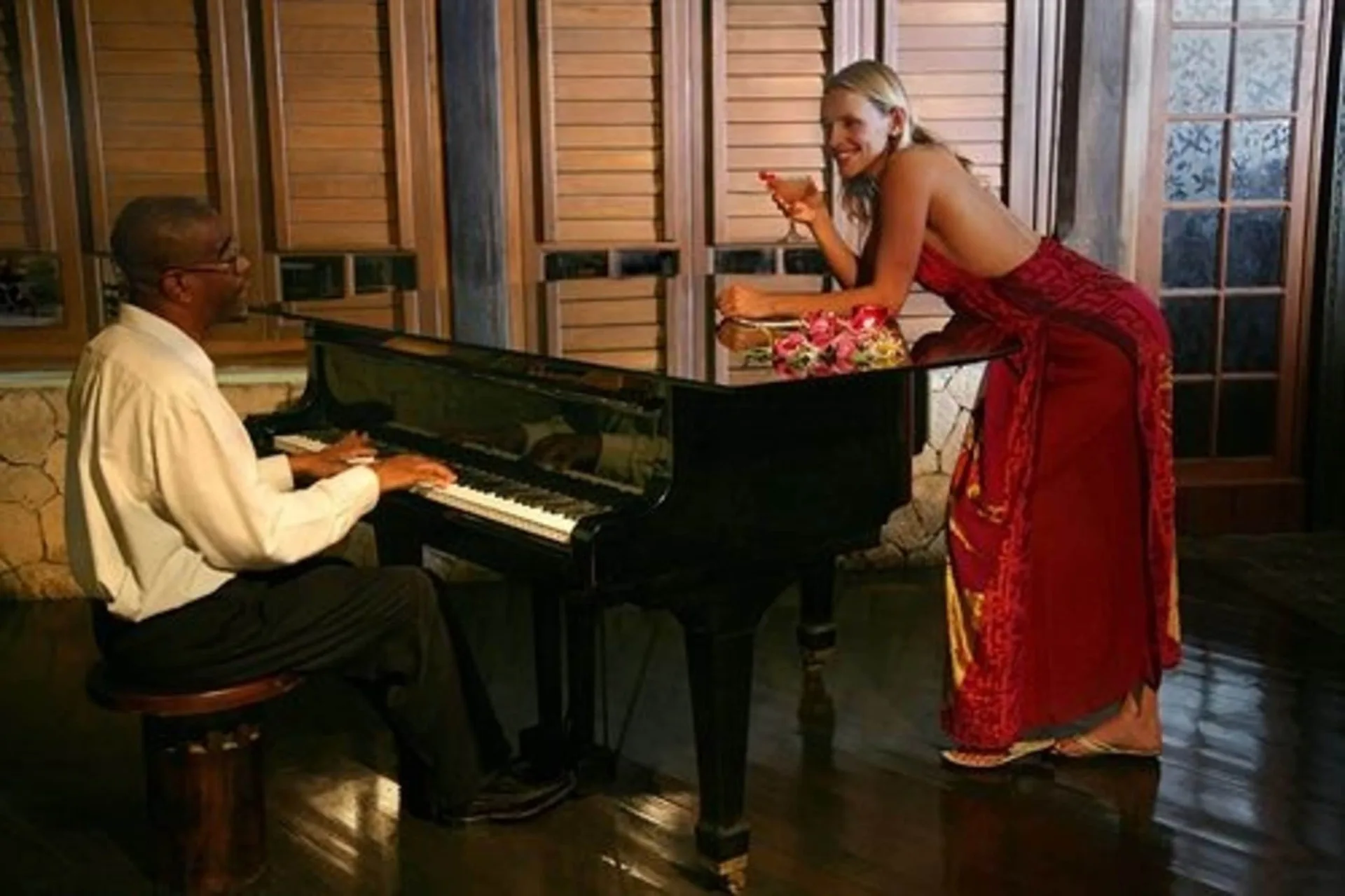 Pianist performing beside a guest in a red dress at Sunset at the Palms Resort.