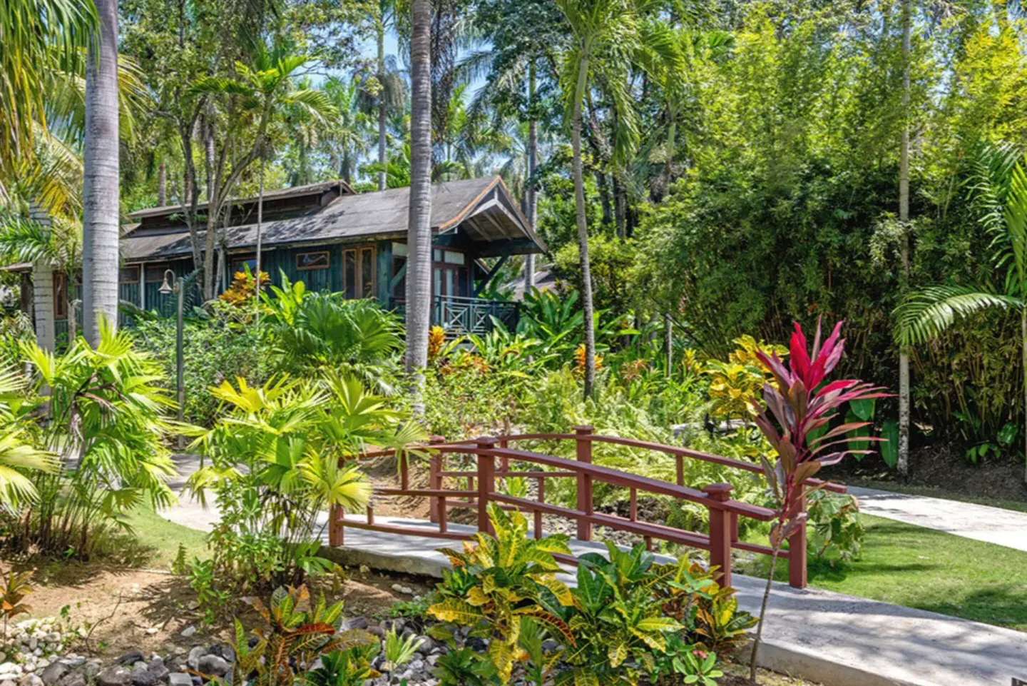 Tropical garden bridge and treehouse-style building at Sunset at the Palms Resort.