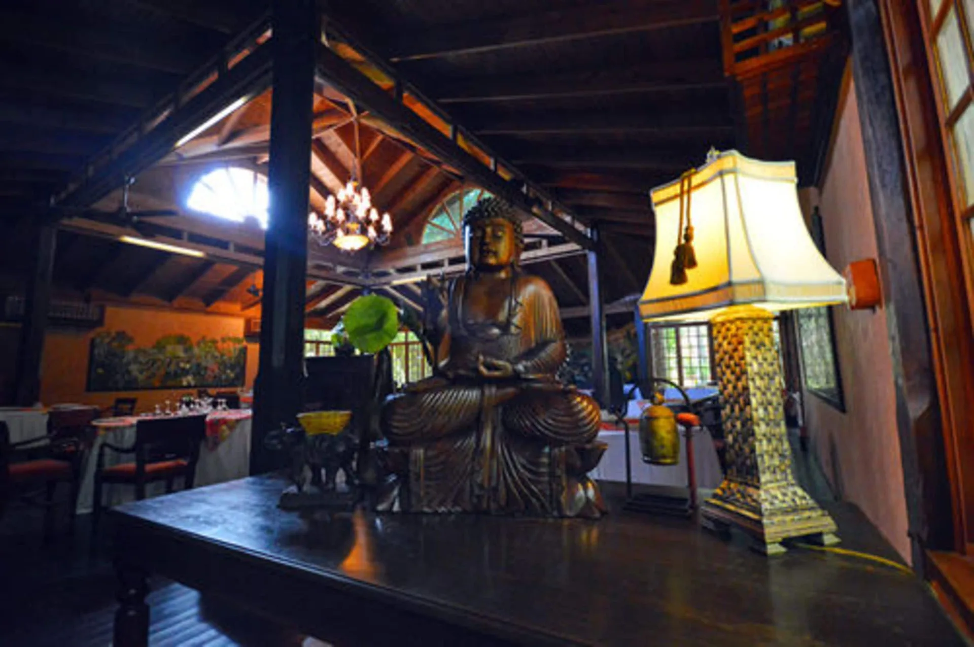 Dining room decor with a seated statue and lamp at Sunset at the Palms Resort.
