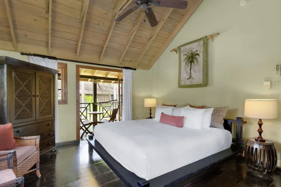 King bed in a Treetop 1-Bedroom Suite at Sunset at the Palms Resort opening to a balcony.