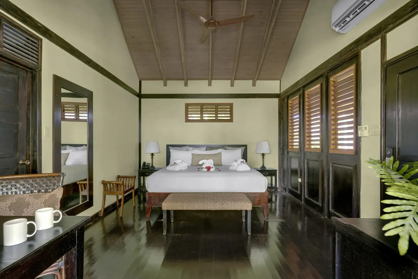 Treetop Standard king bed guest room with wood floors at Sunset at the Palms Resort.