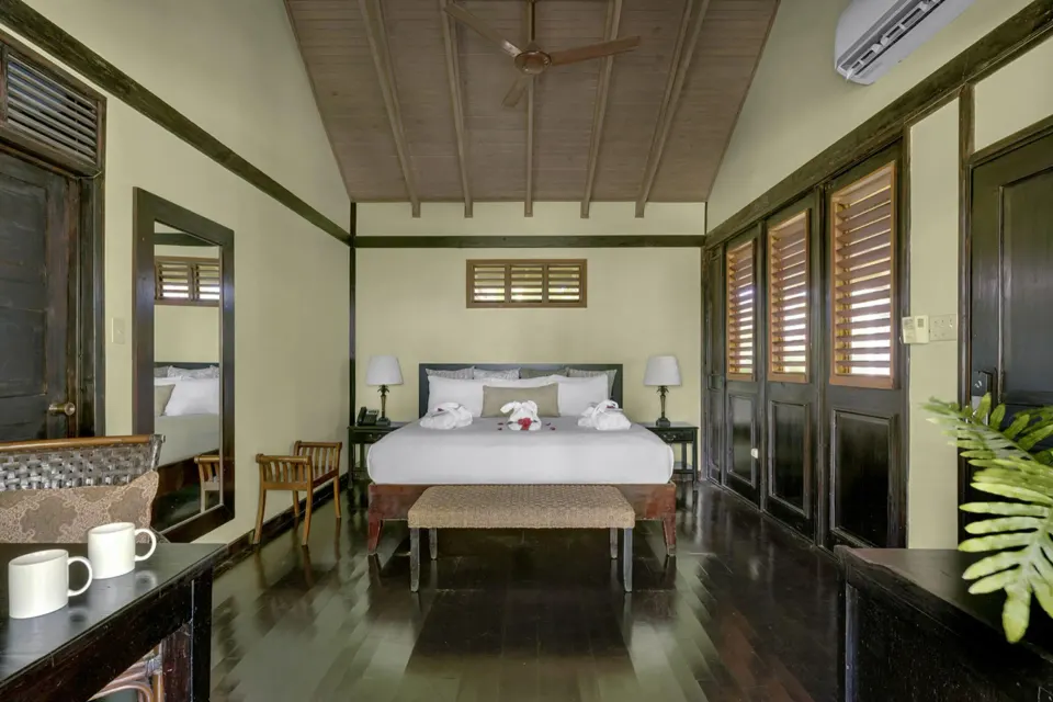 Treetop Standard king bed guest room with wood floors at Sunset at the Palms Resort.