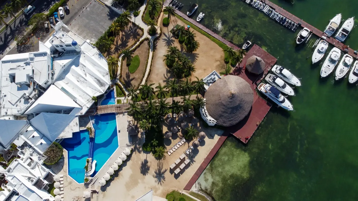 Aerial view of the pool, marina docks, and palms at Sunset Marina Resort & Yacht Club.