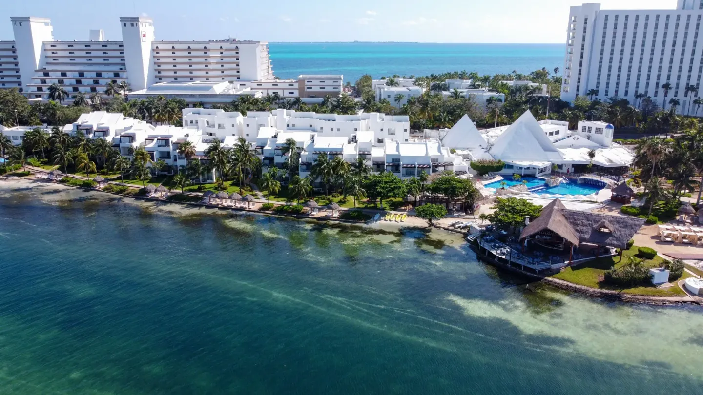 Aerial view of waterfront buildings and pool at Sunset Marina Resort & Yacht Club.