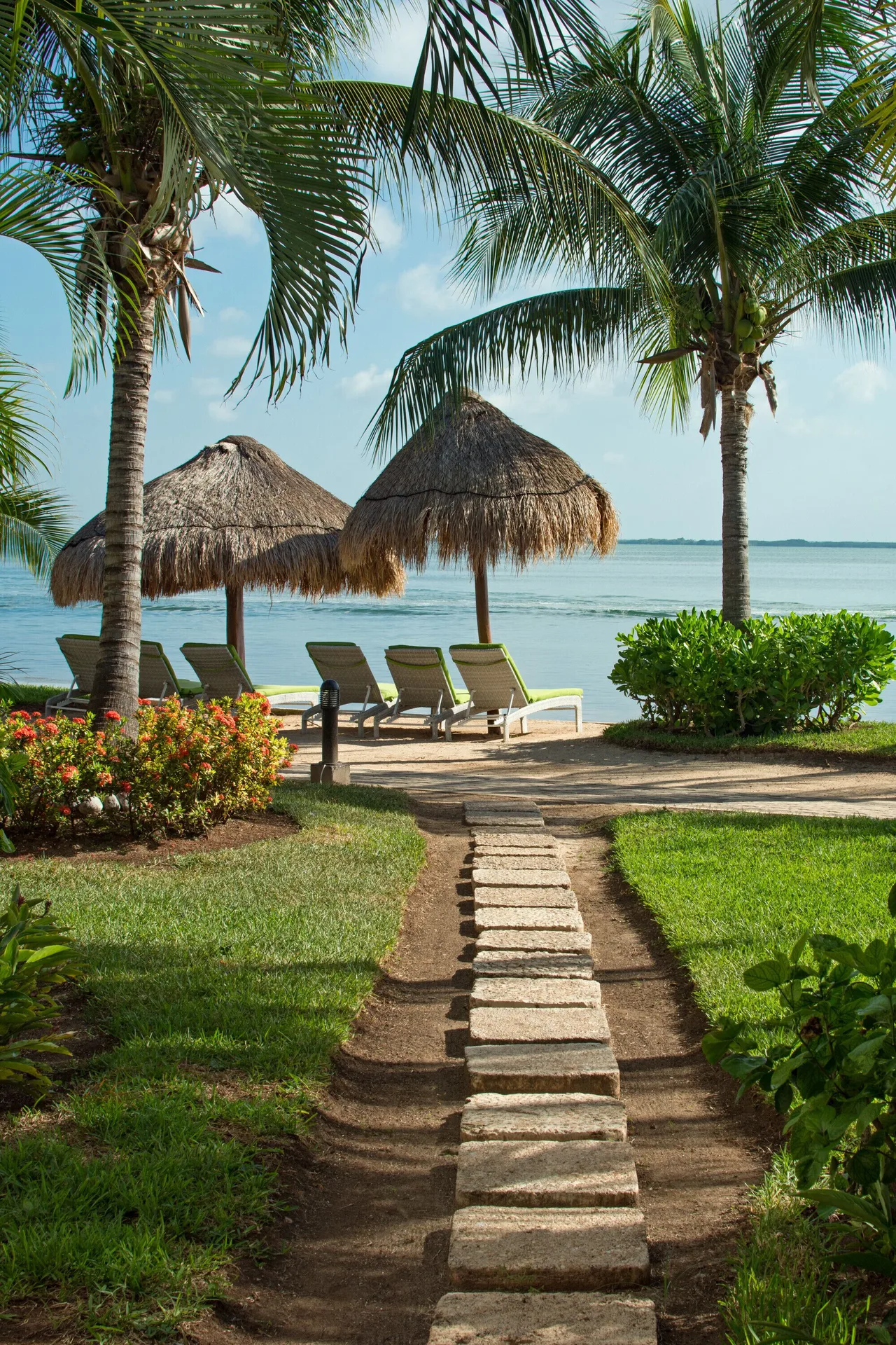 Garden path leading to palapas by the water at Sunset Marina Resort & Yacht Club.
