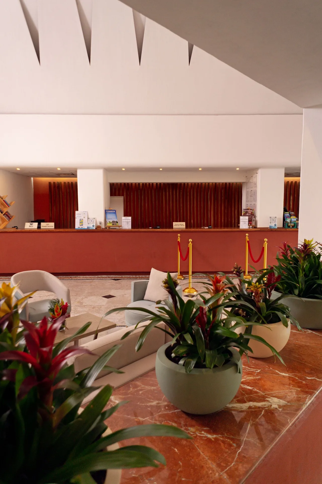 Lobby reception desk with plants and seating at Sunset Marina Resort & Yacht Club.