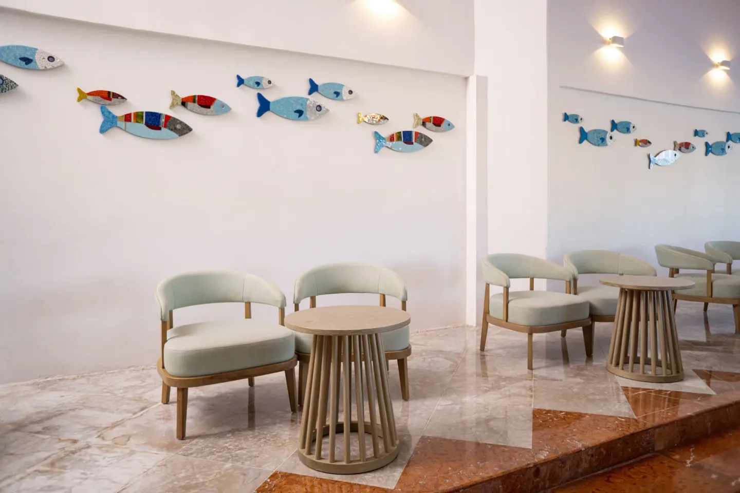 Lobby seating with fish wall art at Sunset Marina Resort & Yacht Club.