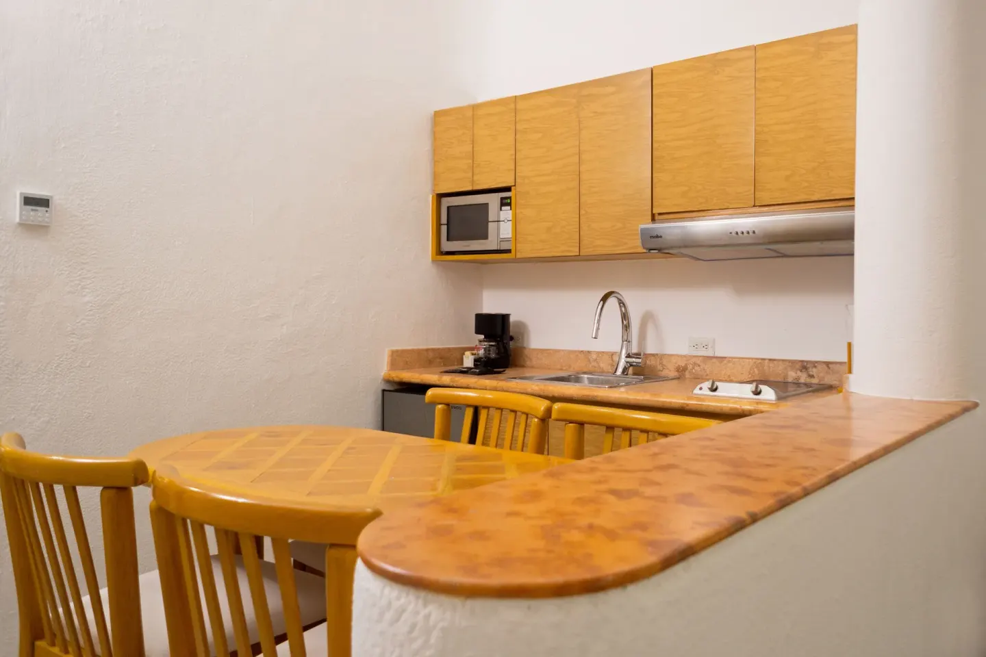 Suite kitchenette with dining table at Sunset Marina Resort & Yacht Club.