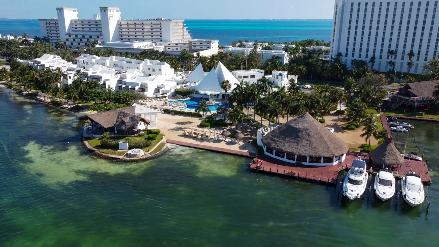 Aerial view of the waterfront, marina, pool, and resort grounds at Sunset Marina Resort & Yacht Club.