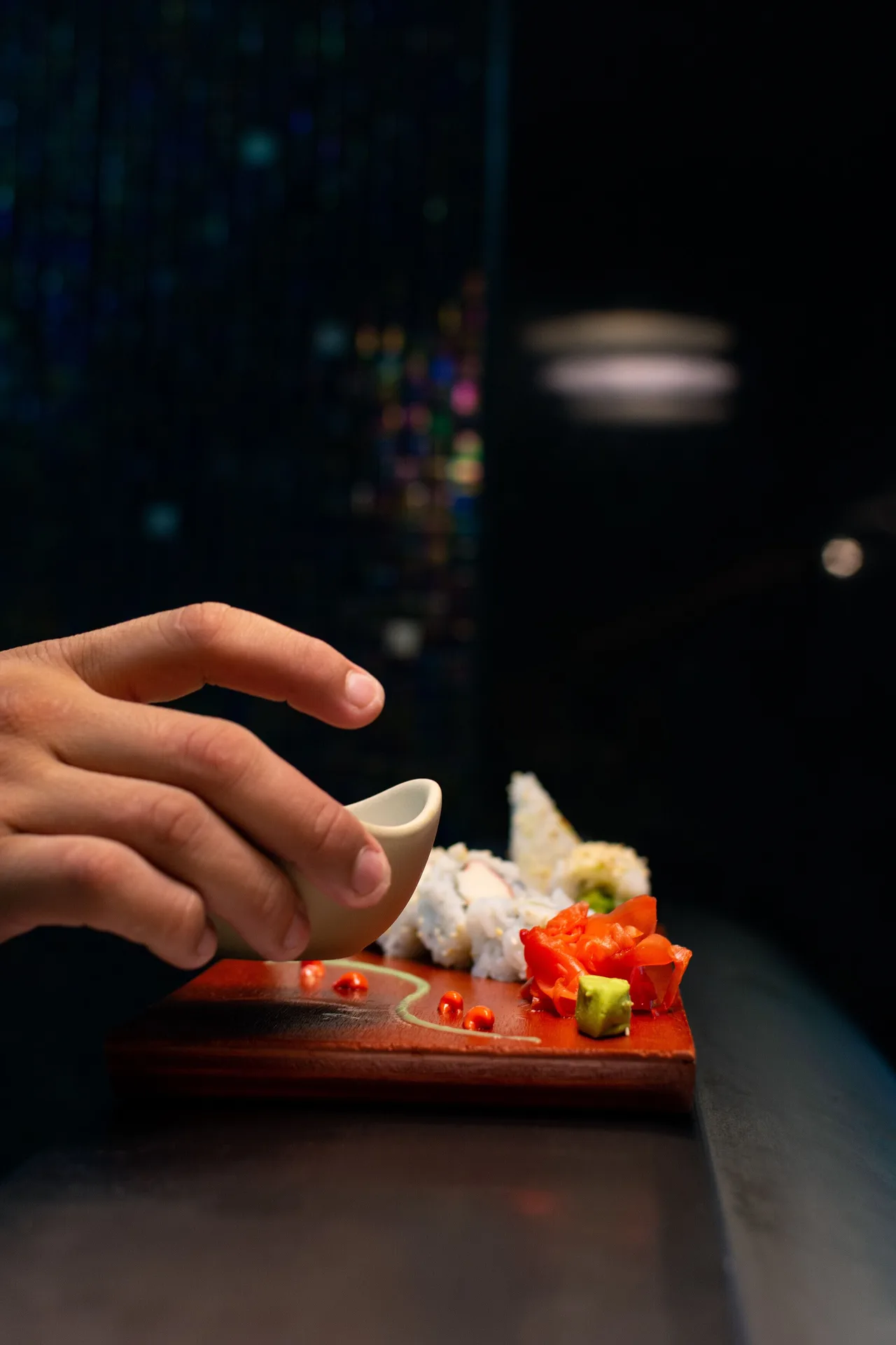 Sushi being served with sauce at Sunset Marina Resort & Yacht Club.