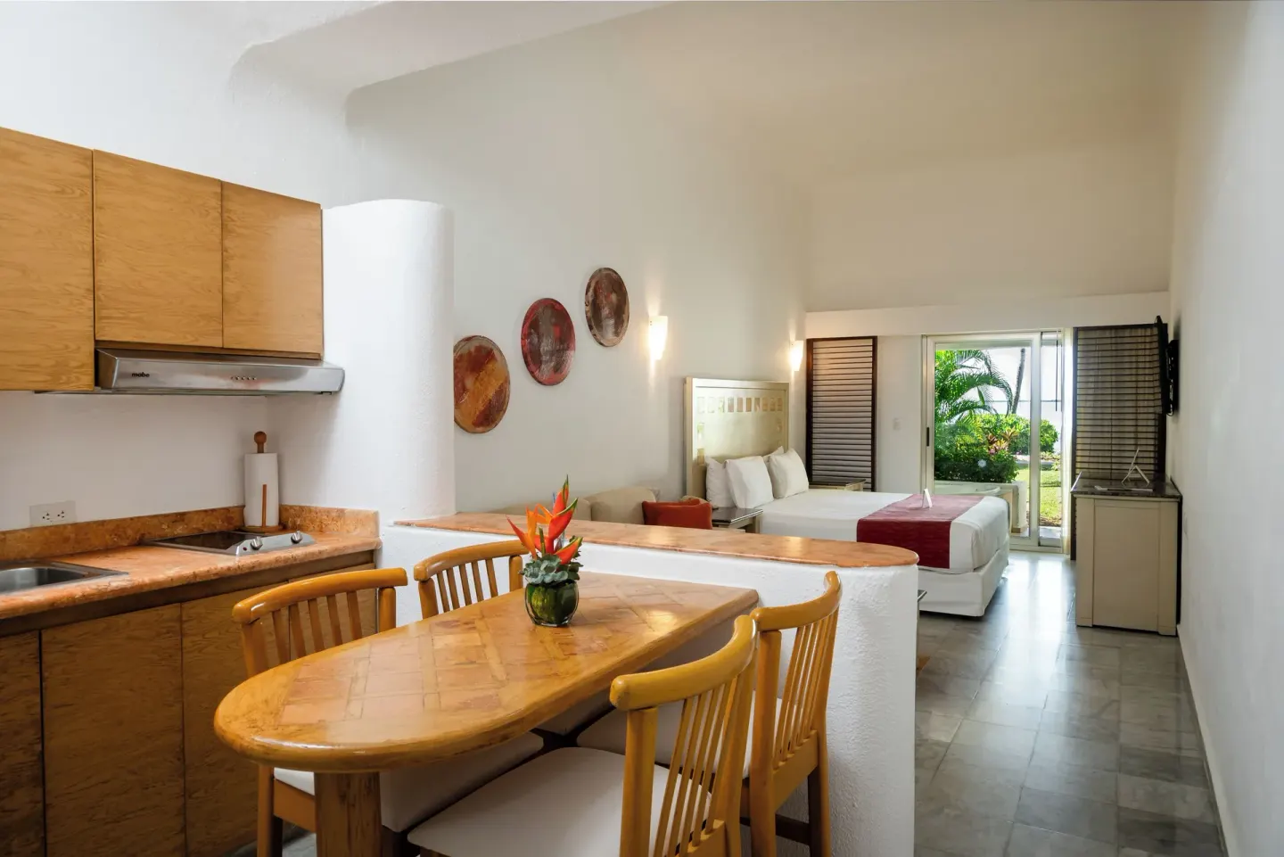 Family Junior Suite with kitchenette, dining table, and bed at Sunset Marina Resort & Yacht Club.