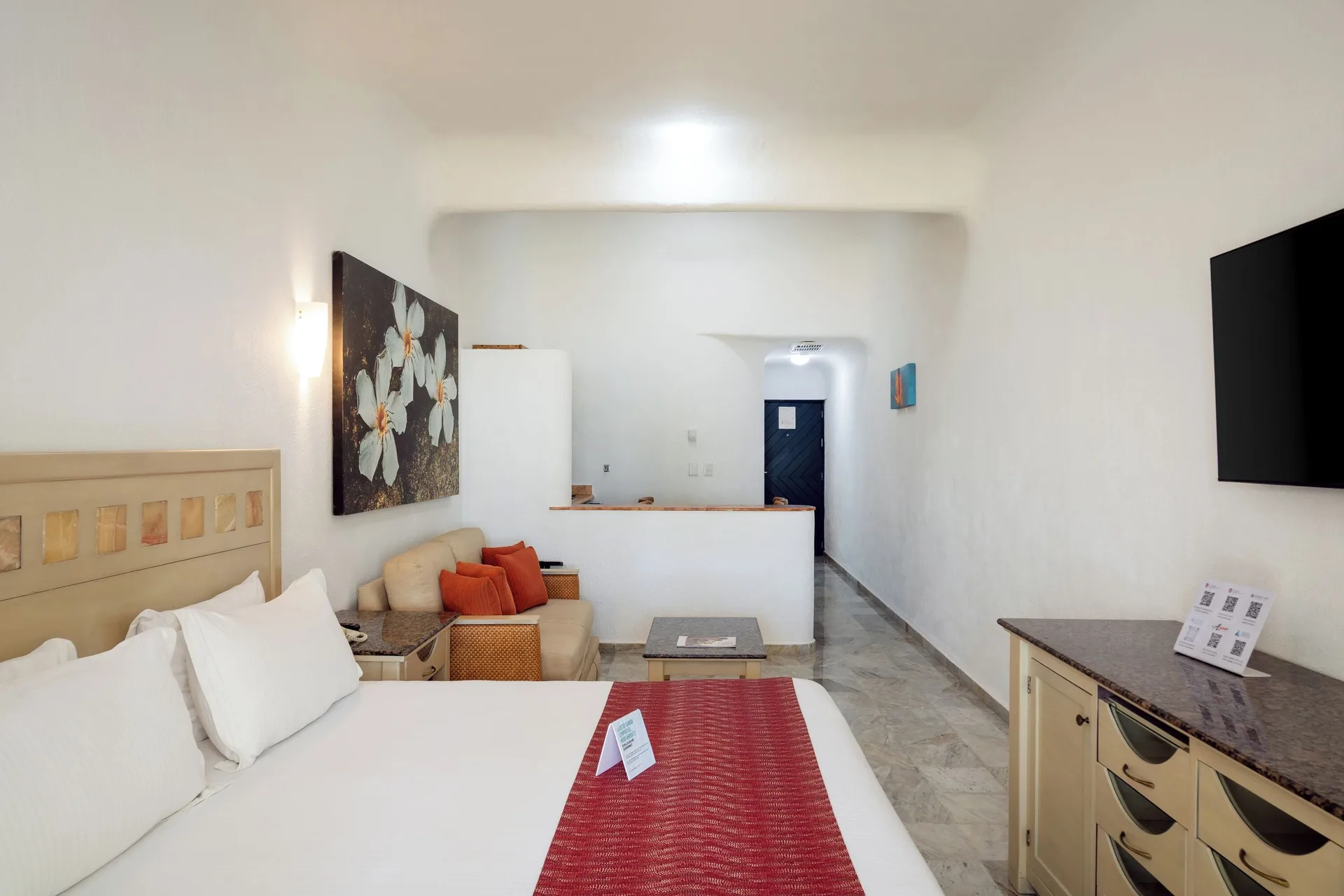 King bed and sitting area in a Standard Room Garden View at Sunset Marina Resort & Yacht Club.