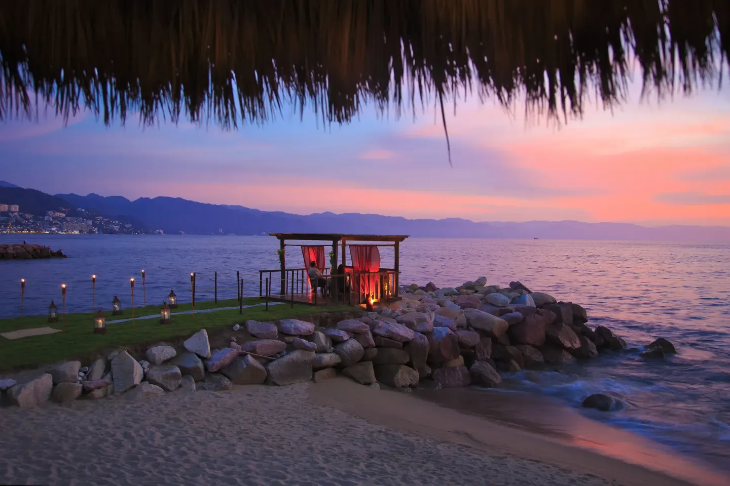 Beachfront cabana at sunset at Sunset Plaza Beach Resort & Spa Pto Vallarta.