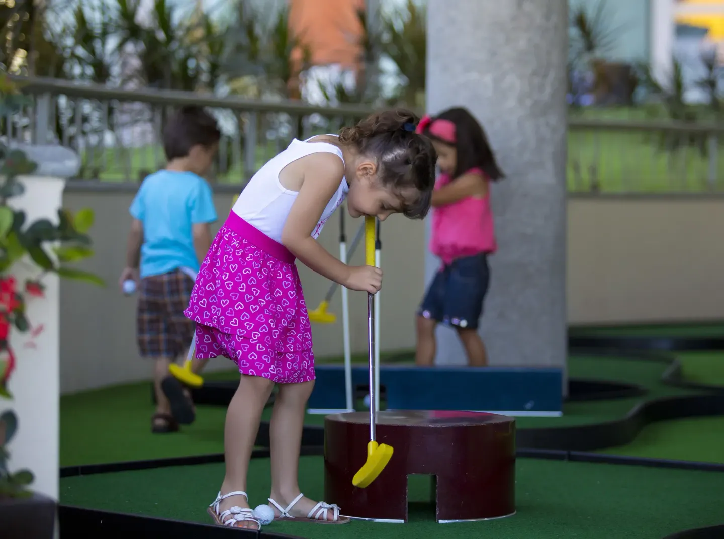 Child playing mini golf at Sunset Plaza Beach Resort & Spa Pto Vallarta.