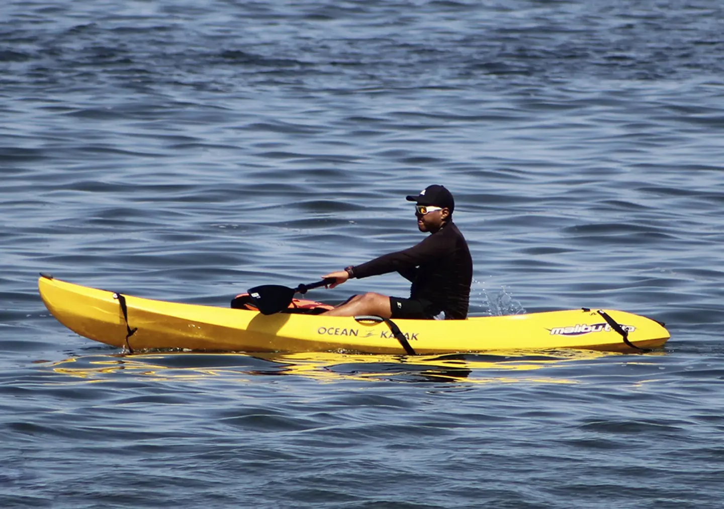 Guest kayaking on calm ocean water at Sunset Plaza Beach Resort & Spa Pto Vallarta.