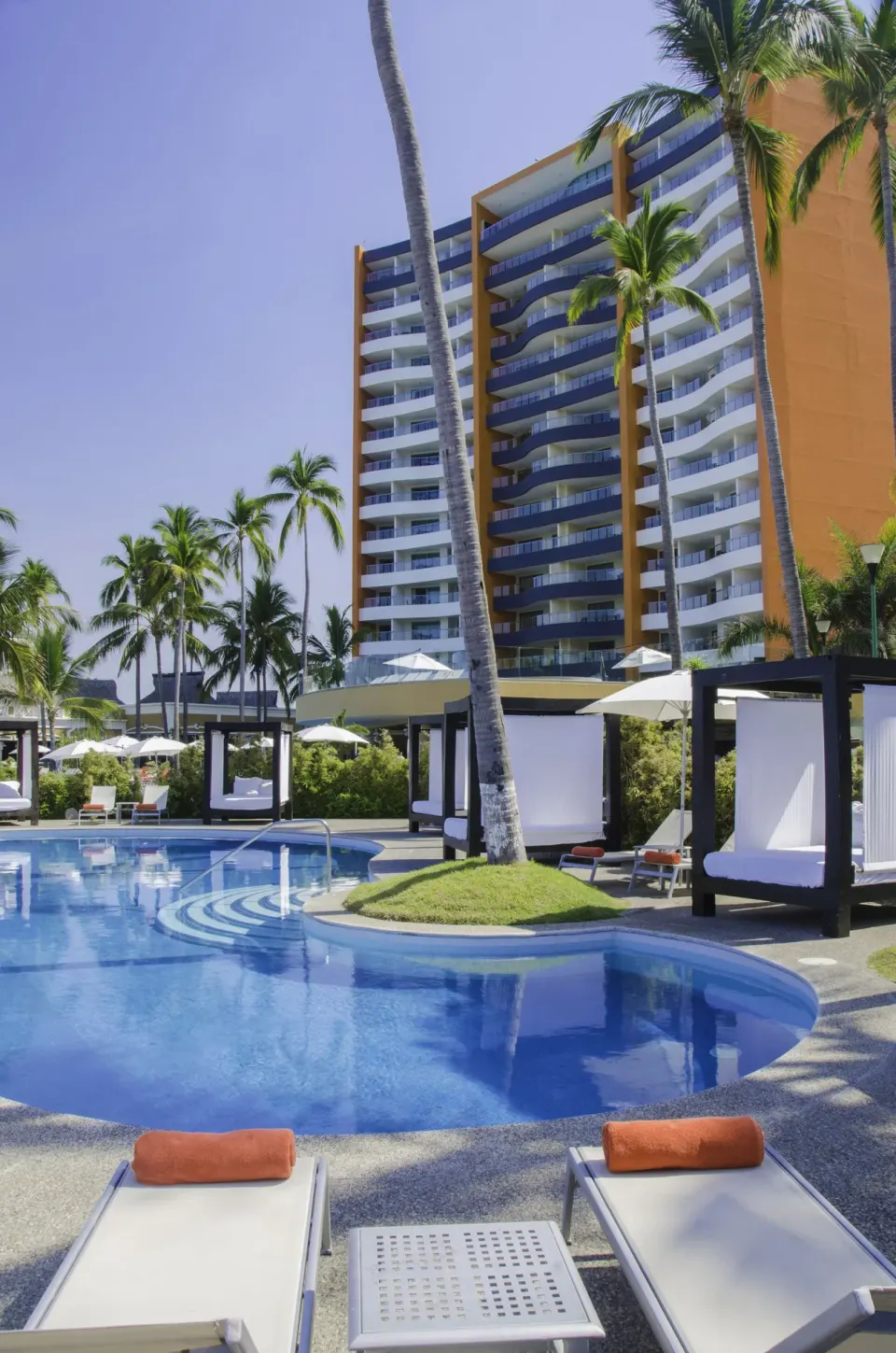 Poolside loungers and cabanas at Sunset Plaza Beach Resort & Spa Pto Vallarta.