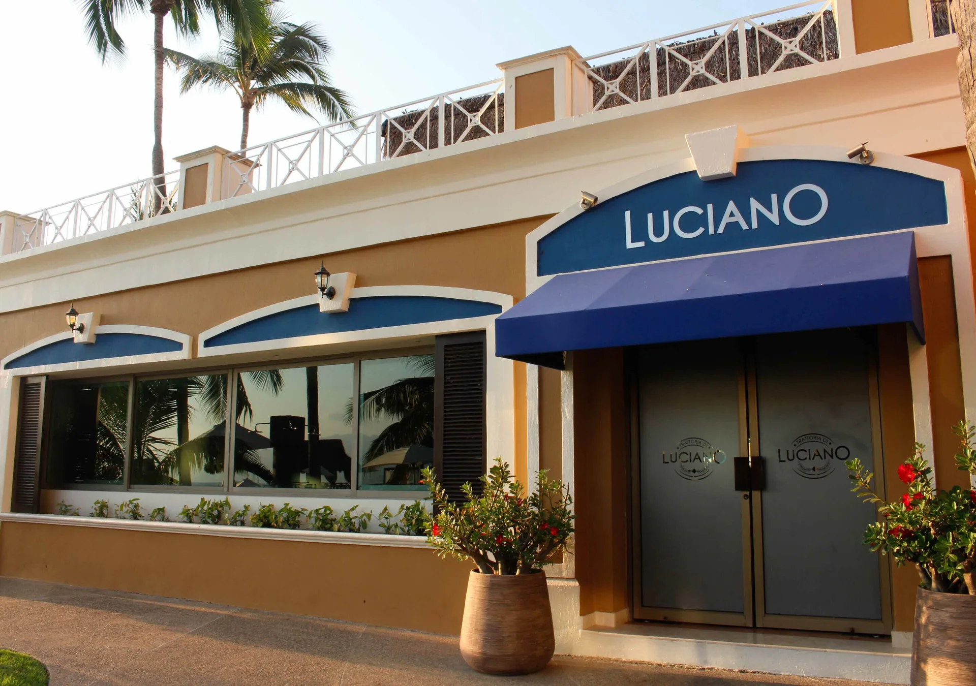Luciano entrance with blue awning at Sunset Plaza Beach Resort & Spa Pto Vallarta.