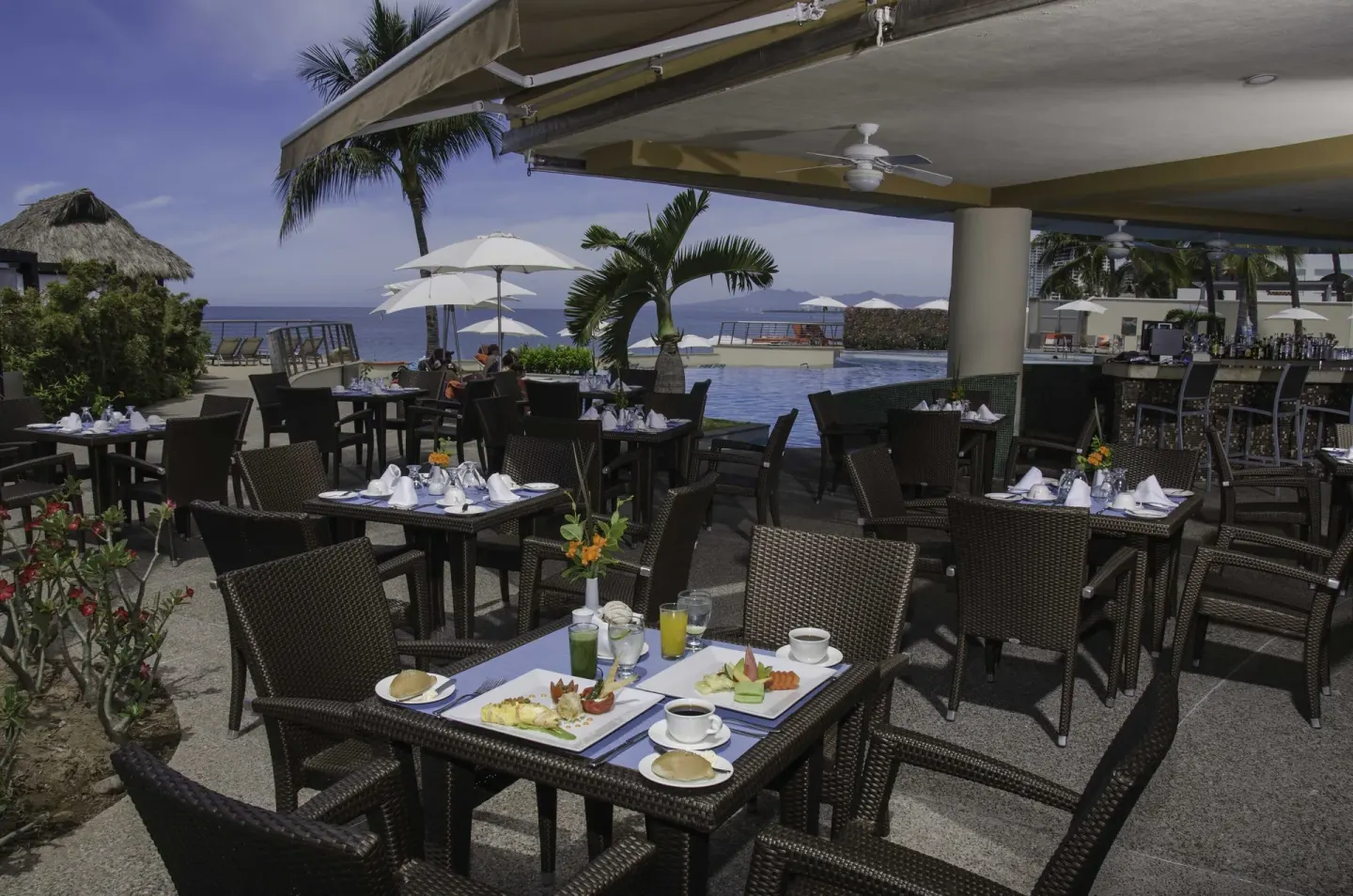 Poolside outdoor dining terrace at Sunset Plaza Beach Resort & Spa Pto Vallarta.