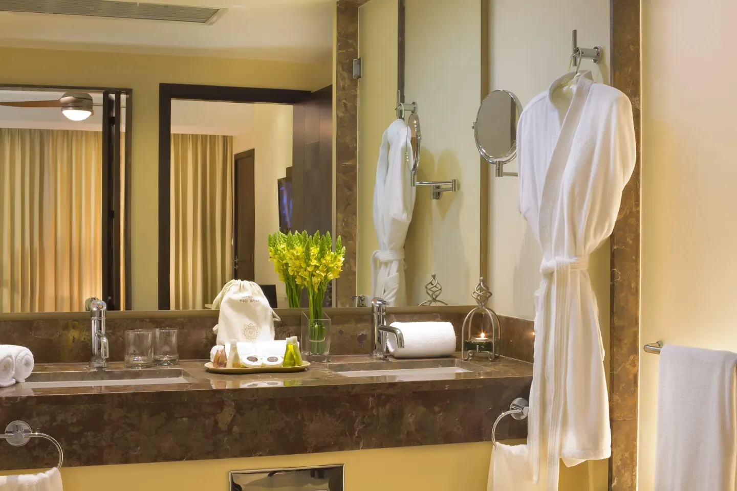 Deluxe Ocean Front bathroom vanity with robes at Sunset Plaza Beach Resort & Spa Pto Vallarta.