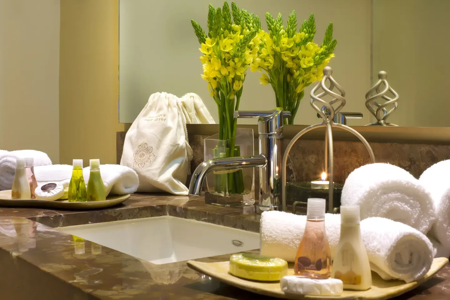 Deluxe Ocean Front bathroom vanity with towels and amenities at Sunset Plaza Beach Resort & Spa Pto Vallarta.