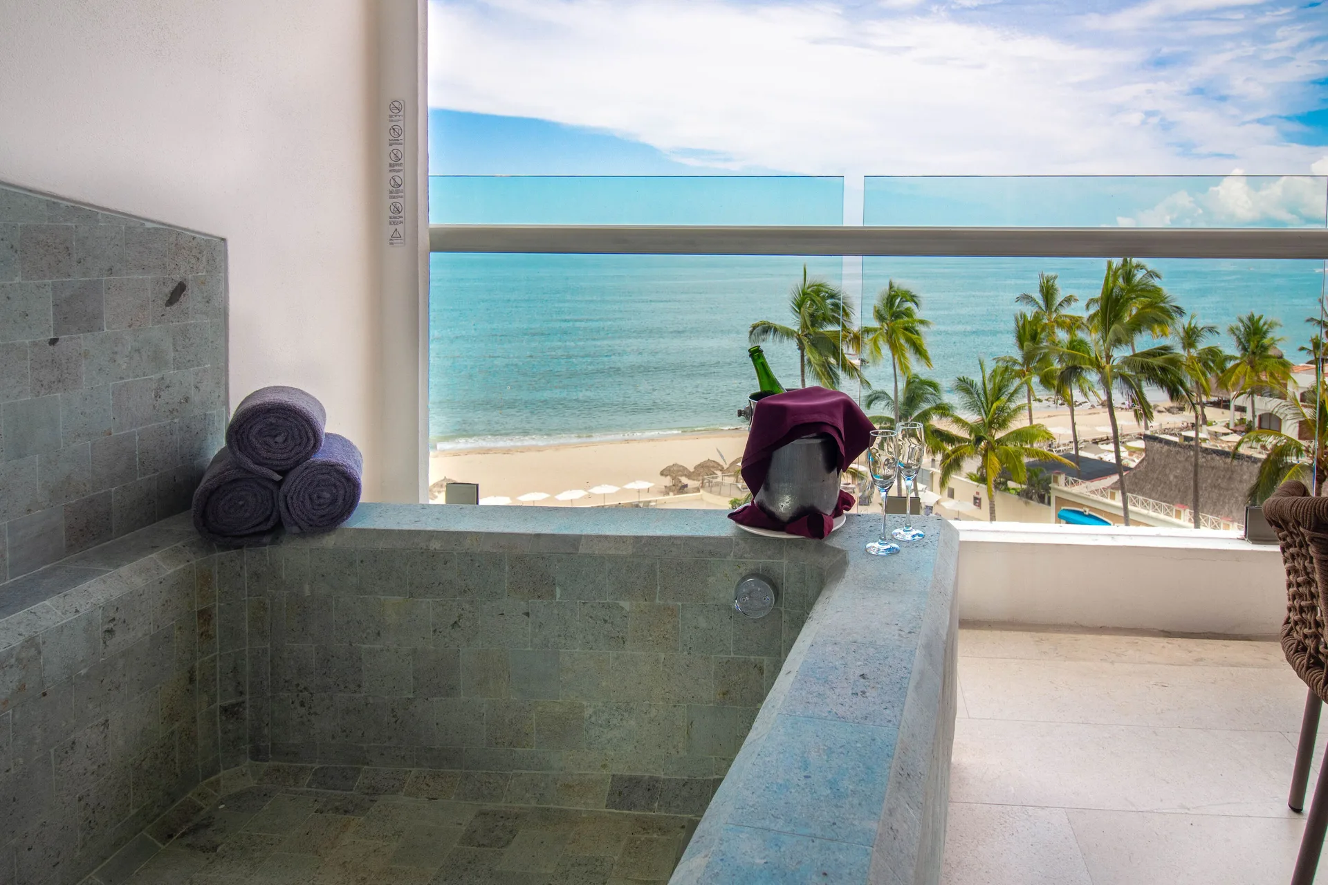Deluxe Premium Suite at Sunset Plaza Beach Resort & Spa Puerto Vallarta with balcony stone tub and sweeping Pacific Ocean views.