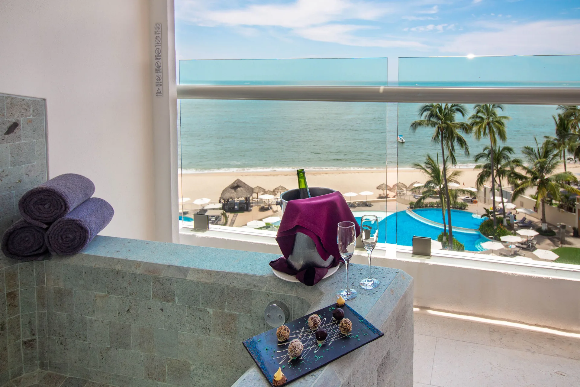 Infinity Suite at Sunset Plaza Beach Resort & Spa Puerto Vallarta with balcony tub, welcome treats, and premium oceanfront design.