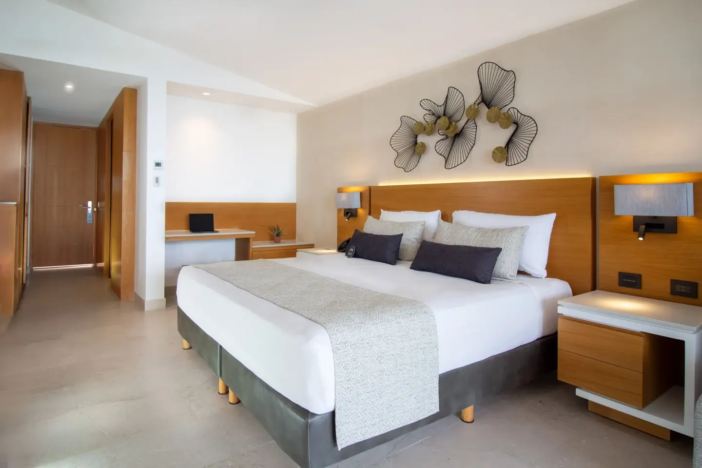 Deluxe Premium Ocean Front king bed and desk area at Sunset Plaza Beach Resort & Spa Pto Vallarta.
