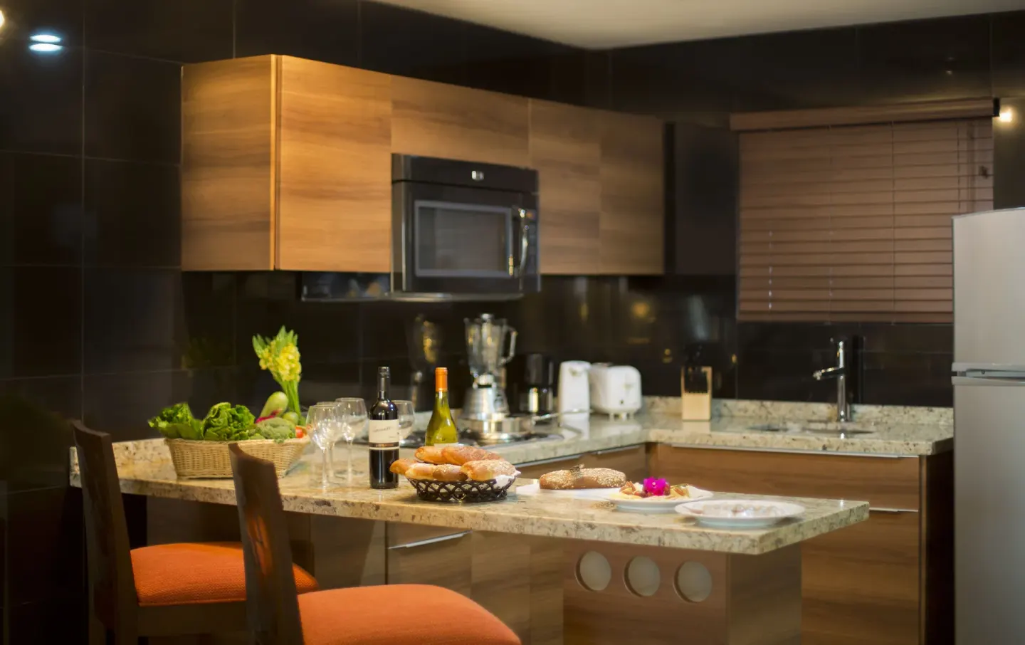 Oceanfront Suite kitchenette and dining chairs at Sunset Plaza Beach Resort & Spa Pto Vallarta.