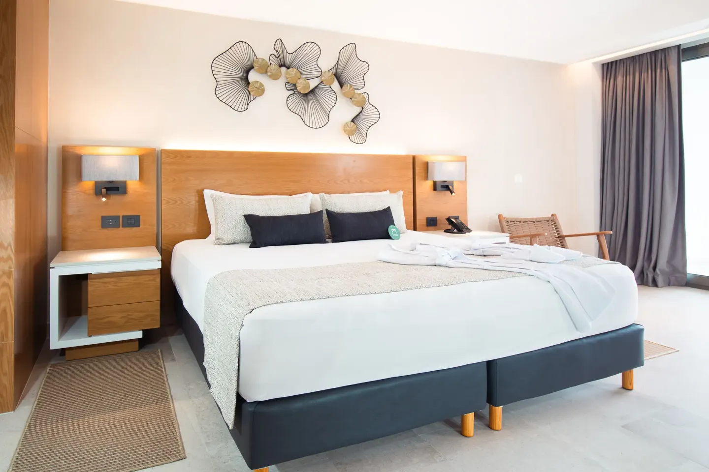 Suite Premium Ocean Front king bed near balcony curtains at Sunset Plaza Beach Resort & Spa Pto Vallarta.