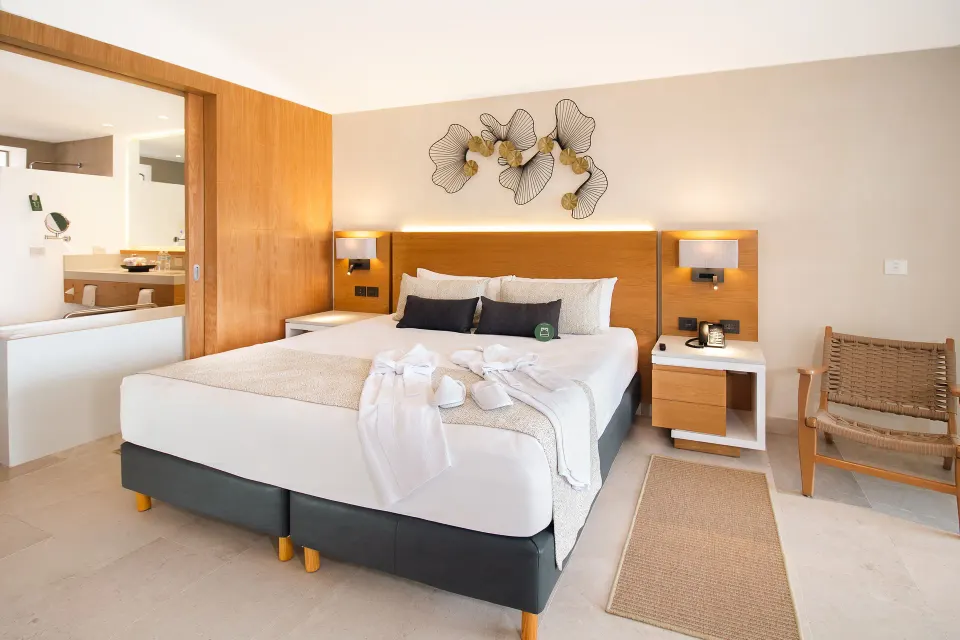 Suite Premium Ocean Front king bed with bedside lamps at Sunset Plaza Beach Resort & Spa Pto Vallarta.