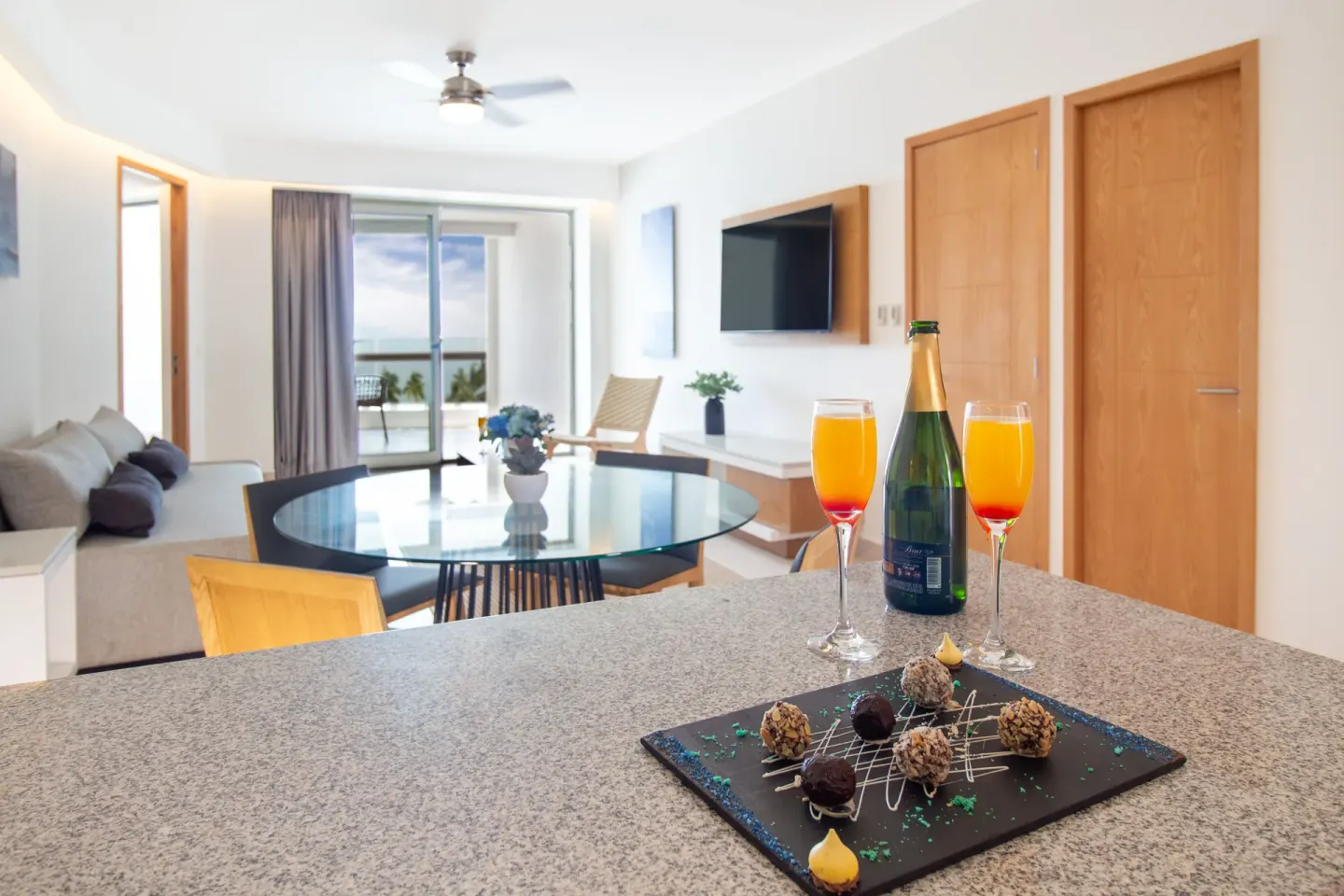 Premium Ocean Front suite counter at Sunset Plaza Beach Resort & Spa Pto Vallarta with drinks and ocean beyond.