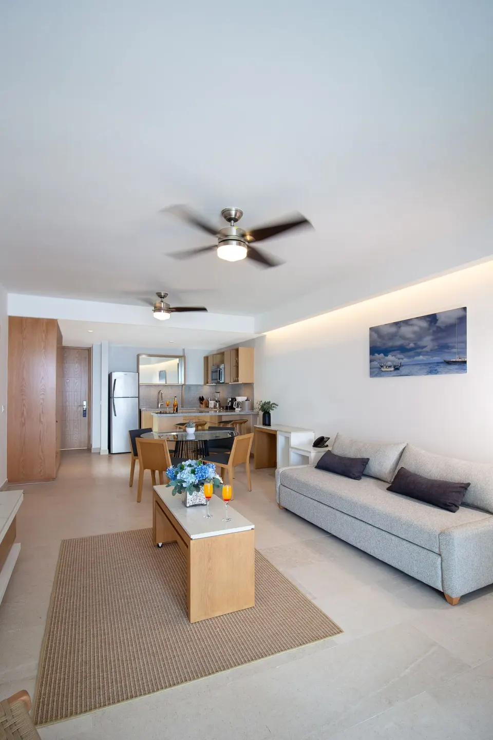Premium Ocean Front suite living room at Sunset Plaza Beach Resort & Spa Pto Vallarta with sofa and kitchenette.