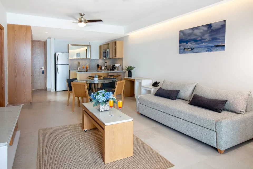 Premium Ocean Front suite lounge at Sunset Plaza Beach Resort & Spa Pto Vallarta with sofa, table, and kitchen.