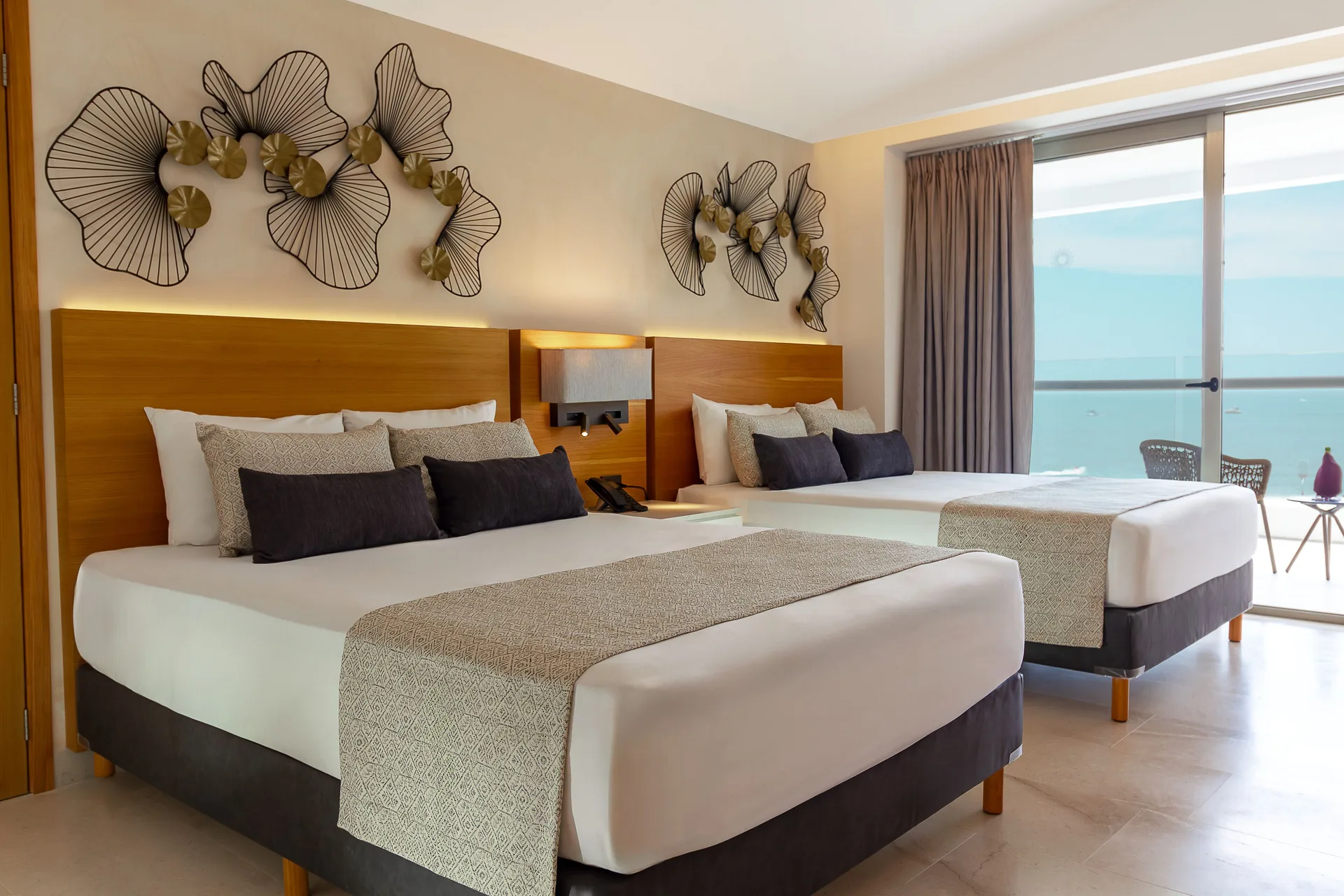 Superior Deluxe Ocean Front room with two beds and balcony at Sunset Plaza Beach Resort & Spa Pto Vallarta.