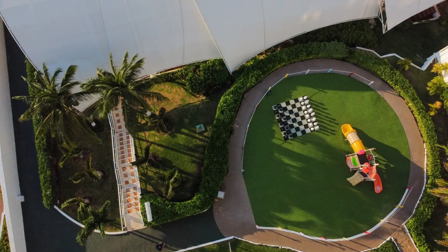 Aerial view of play lawn and oversized chess at Sunset Royal Beach Resort.