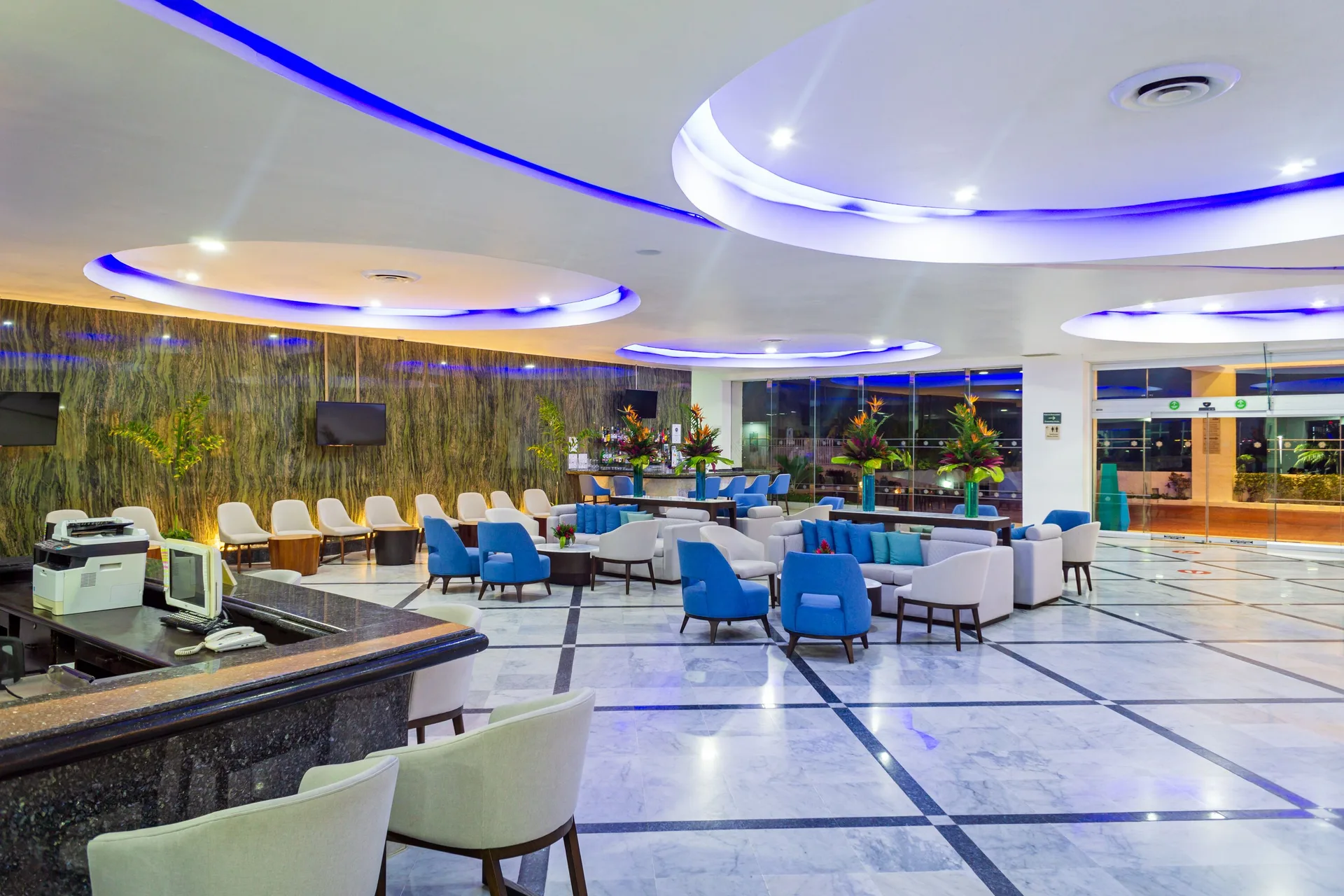 Lobby seating area with blue accent lighting at Sunset Royal Beach Resort.
